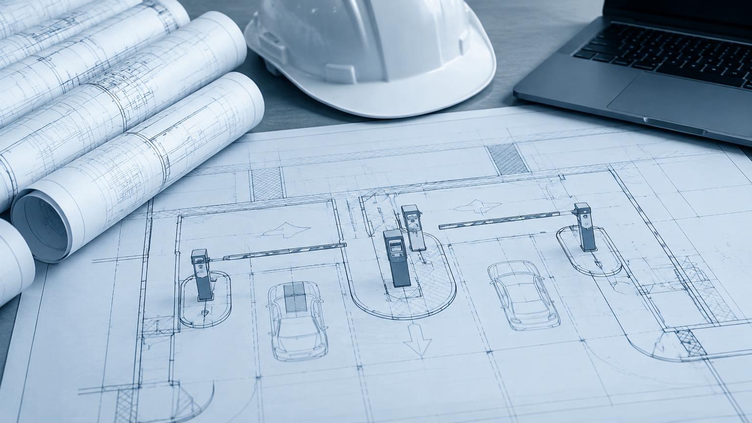 Project plans and system layout drawings on a work table